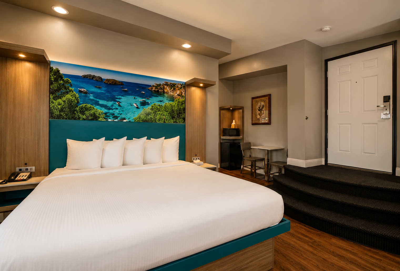 Deluxe King Jacuzzi room with king bed, coastal mural, and raised entry steps