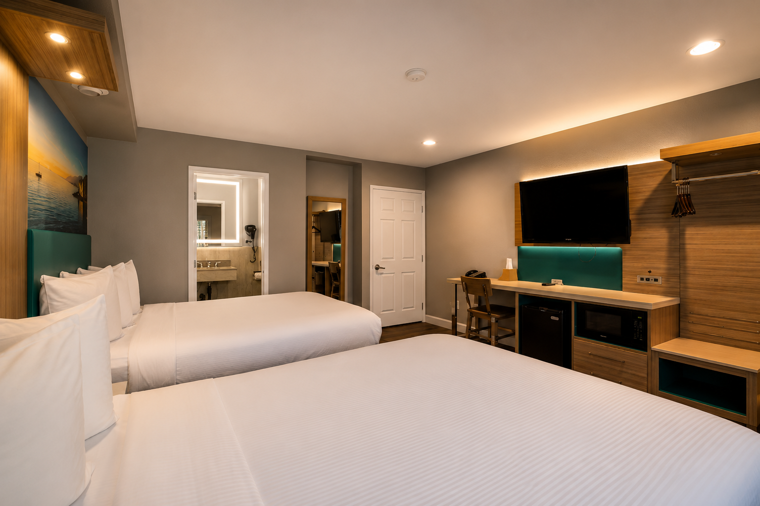 Standard 2-Queen room with two beds, wall-mounted TV, and bathroom view