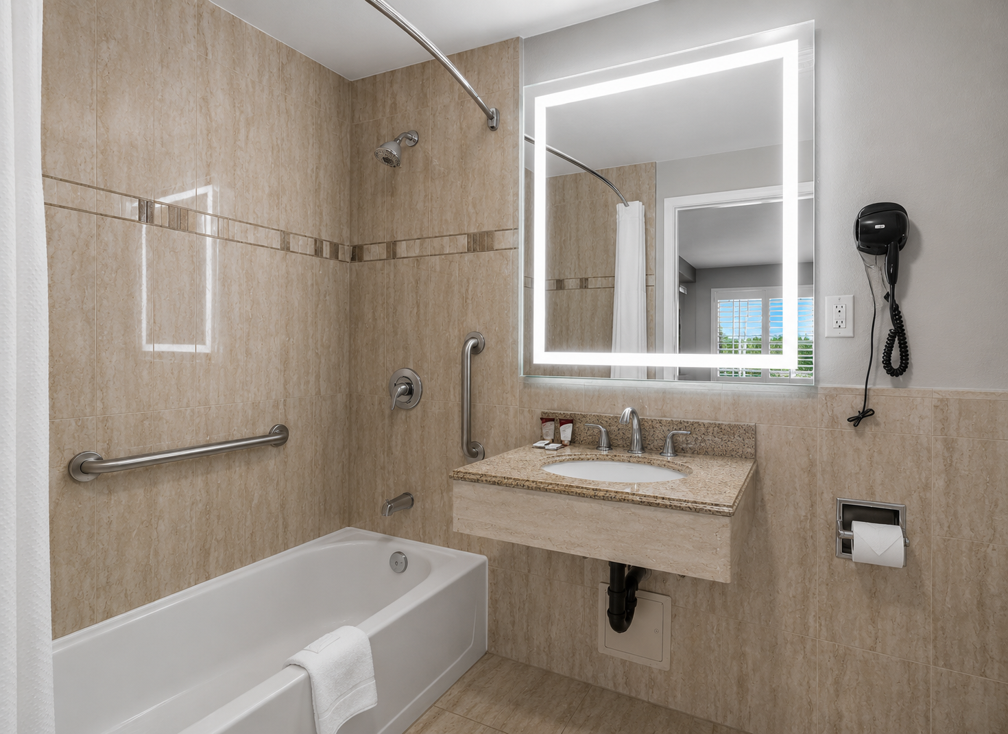 Standard 2-Queen bathroom with tub-shower combo and lighted vanity mirror