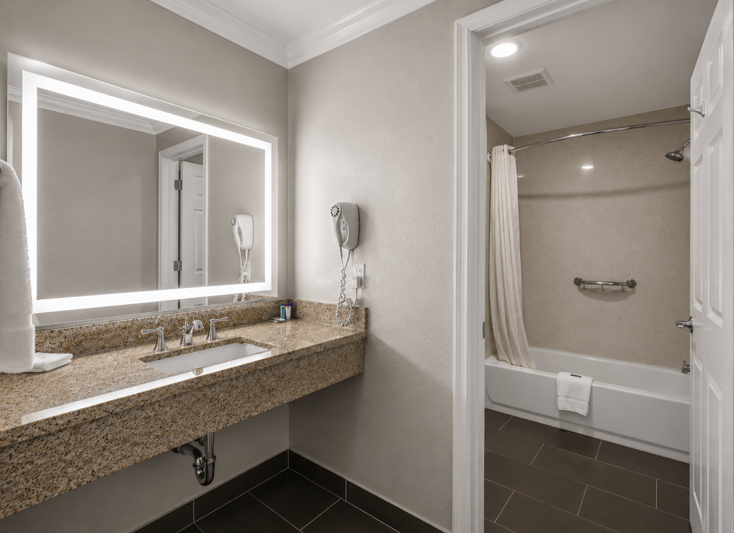 Standard Queen bathroom with granite vanity and tub-shower behind a curtain